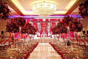 A Grand Wedding hall decorated with multiple color flowers 